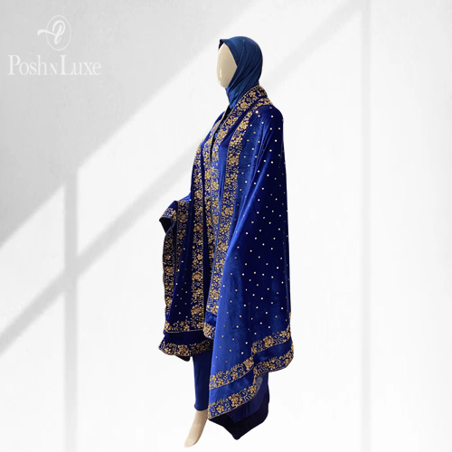embroidered velvet shawl woman wearing a blue hand embroidered shawl. The shawl features double embroidered border on all four edges of the velvet shawl.