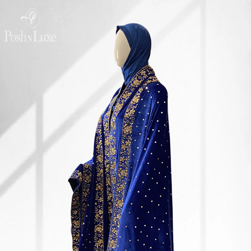 shawls brands in pakistan woman wearing a blue hand embroidered shawl. The shawl features double embroidered border on all four edges of the velvet shawl.